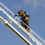 Firefighter climbing latter
